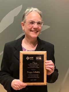 Dr. Schultz with award
