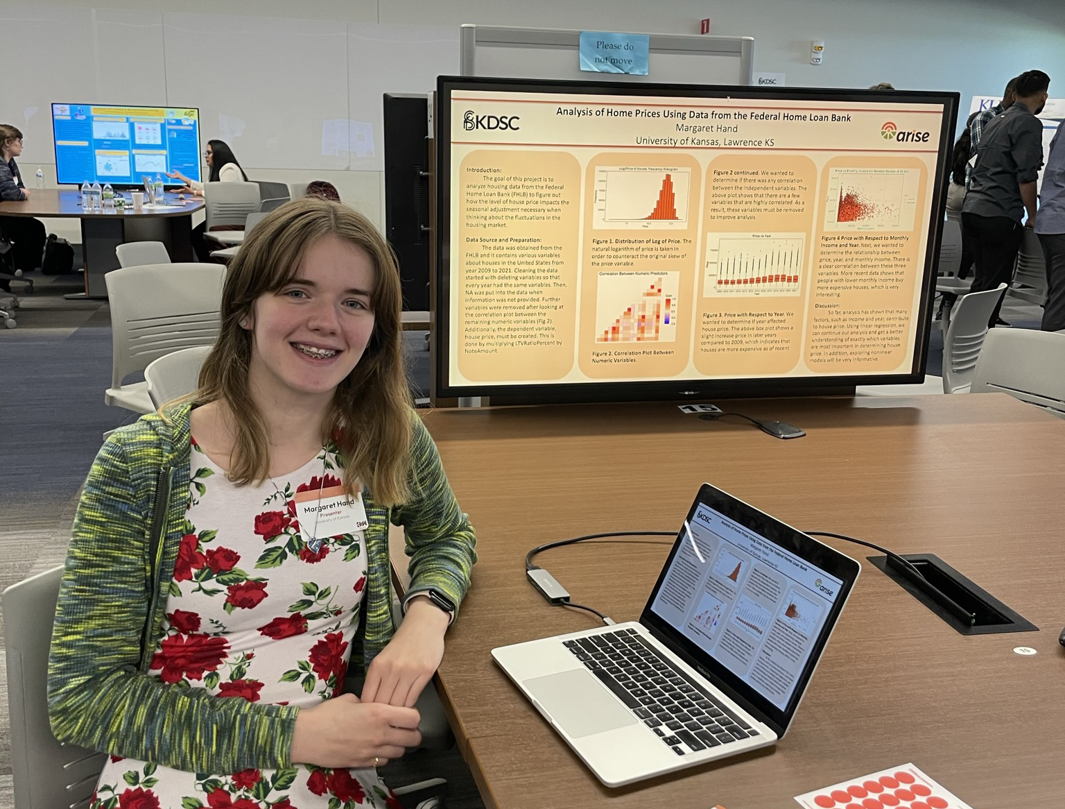 Student displays poster on data science project