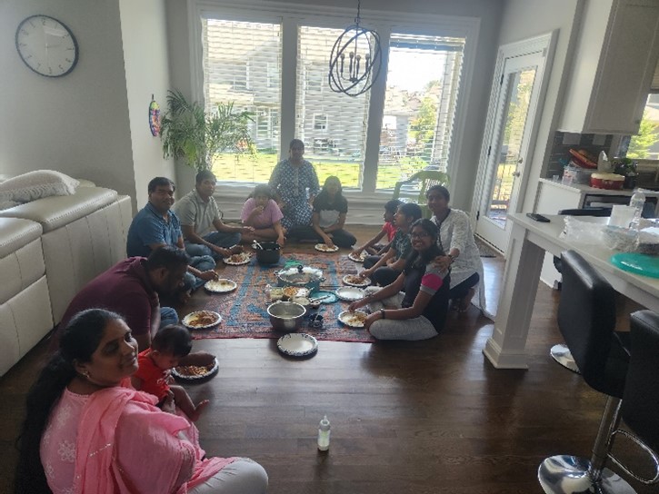 family eating a meal together sitting on the floor